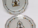 two plates with designs on them are sitting on a table