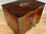 a small wooden box sitting on a wooden table