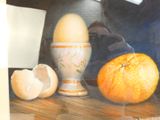 a picture of an egg and an orange on a table
