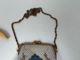 a small purse with a bird on it next to a banana