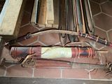 many different types of baseball bats on display on the floor