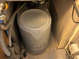 an image of a water heater under a kitchen counter