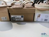 three pairs of women ' s sandals in a box on a table