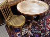 a table and two chairs in a room with a rug on the floor
