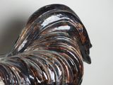 a black and white rooster figurine on a table