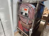 a cart with a bunch of hoses and a roll of plastic