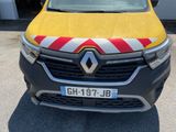 the front of a yellow van with a red and white stripe on it
