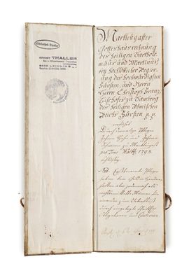 an old book with writing on it sitting on top of a table