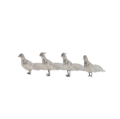 four ducks standing in a line on a white surface