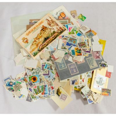 a pile of stamps and postcards sitting on a table