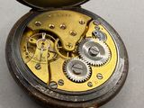 a close up of a pocket watch with gears on the inside of it