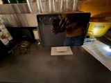 a man that is standing at a counter with a laptop