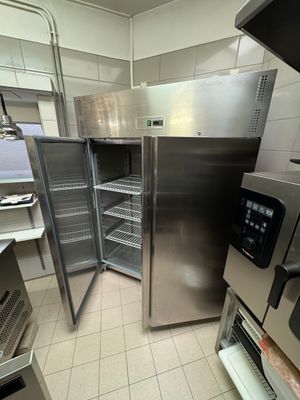 stainless steel refrigerators in a commercial kitchen with a lot of counter space