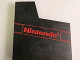 the nintendo logo is shown on the back of a black box