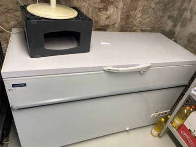 a microwave sitting on top of a refrigerator in a room
