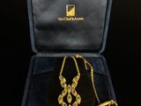 a gold necklace and bracelet set in a velvet case