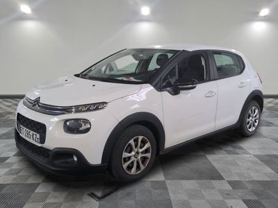 the white citrole is parked on a checkered tile floor