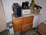 two microwaves on top of a cabinet in a kitchen