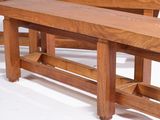 a wooden bench that is sitting next to a table