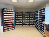 a room with many shelves and bins in it