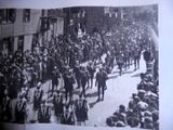 a large crowd of people walking down the street