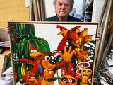 a man that is holding a painting in his hands