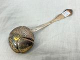 a silver spoon with a metal handle on a table