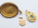 an image of a gold locke with a blue stone in the center and a gold locke with a blue stone in the center