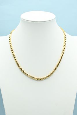 a gold chain necklace on a mannequin mannequin