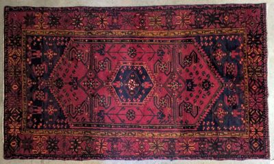 a red and black rug with a design on it