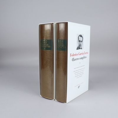 two books sitting on top of each other on a white surface