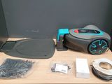 a robot that is sitting on a table next to a roll of tape