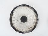 a black and white circular object on a white surface