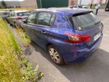 a blue car parked on the side of the road