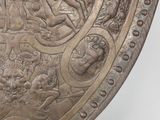 a large metal shield with a design on it