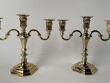 pair of silver plated candlesticks on stands on a white background