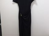a black dress hanging on a white wall in a room