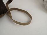 a brown bag with a brown strap sitting on a white table