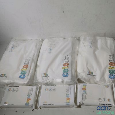 many bags of toilet paper sitting on the floor