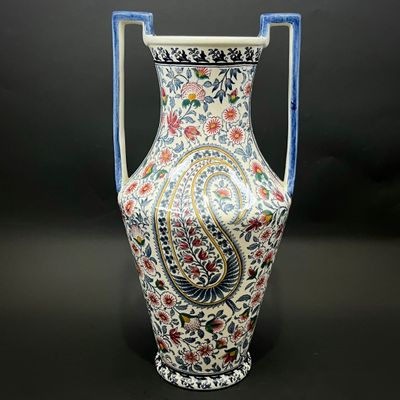 a vase with a handle on a black background