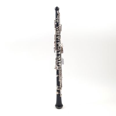 a close up of a clarinet on a white surface with a white background