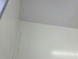 a small bathroom with a toilet and a window