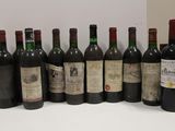 several bottles of wine are lined up in a row on a table