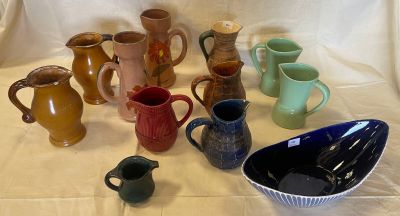 many different types of vases and bowls on the table