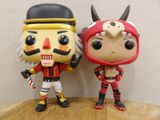 two pop vinyl figures that are standing on a table