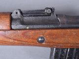 an old rifle with a wooden handle on a gray background