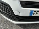 a close up of a white car with a license plate on it