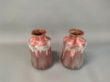 two vases that are sitting on a table