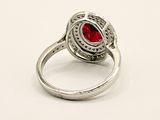 silver ring with a red stone in the center of it