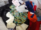 a pile of clothes in a plastic bag on the floor